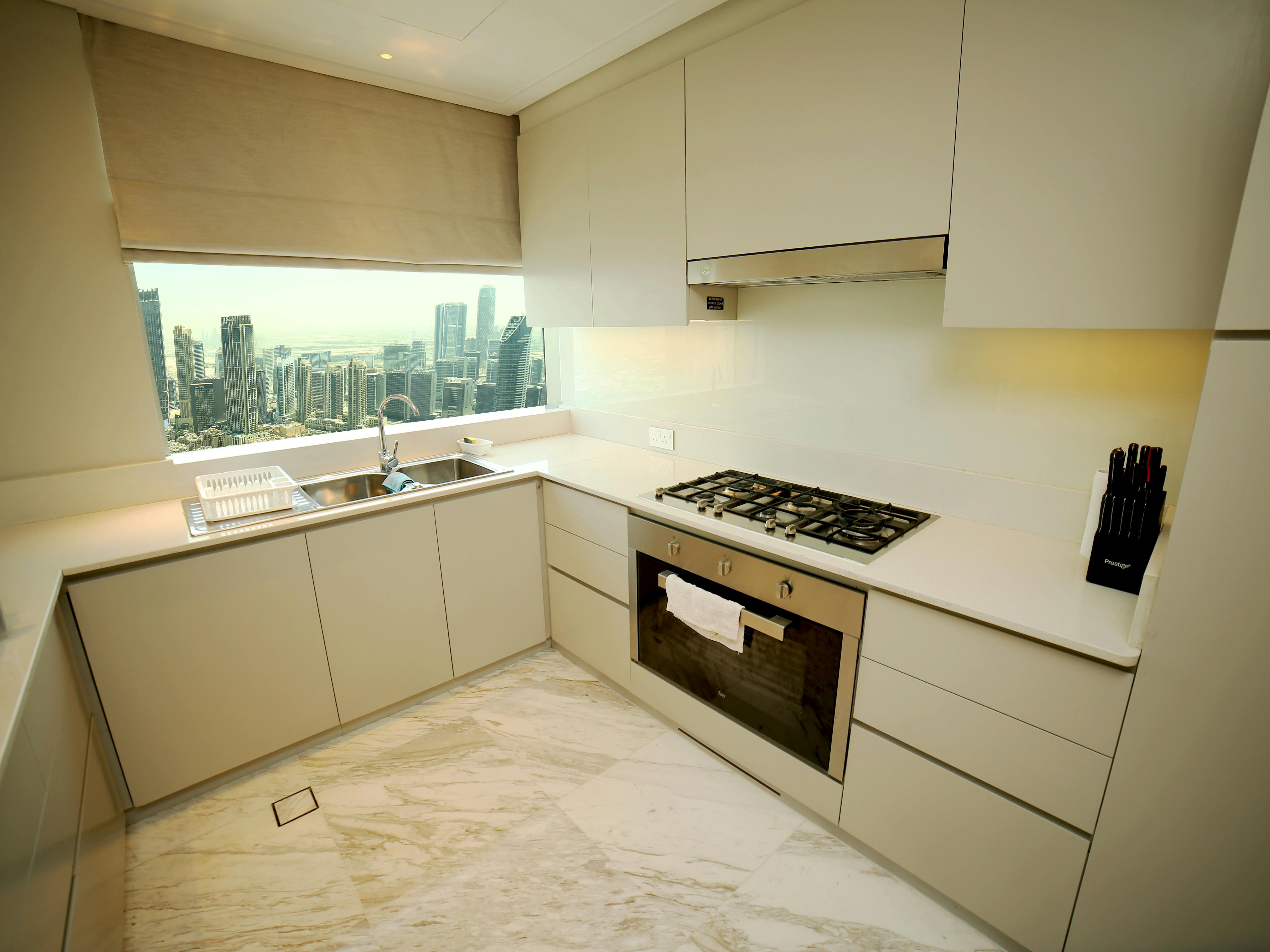 Modern condo interior renovation — premium kitchen with quartz countertop, custom cabinetry, and designer lighting by Proptality Singapore