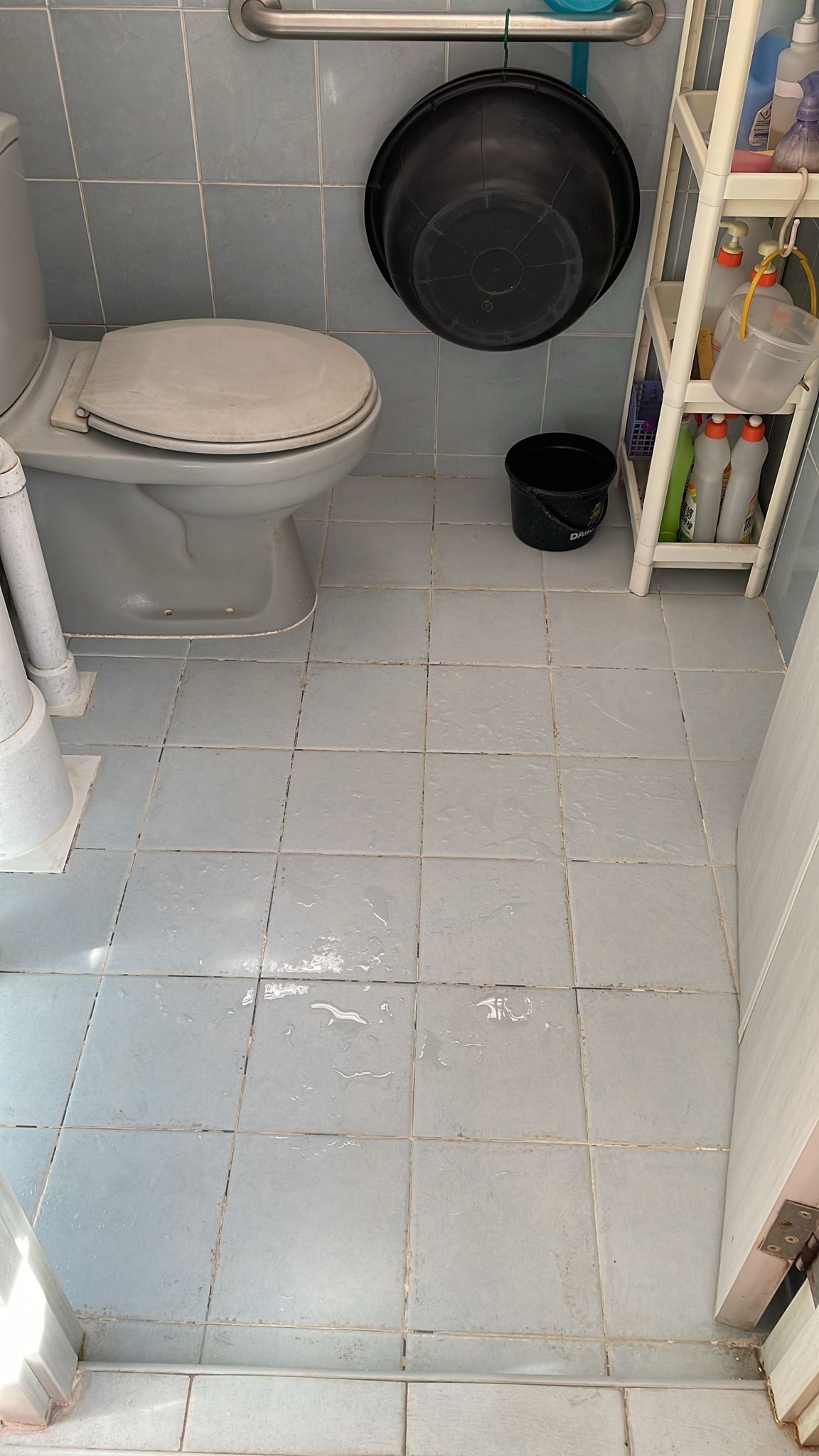 Before: Bathroom with dirty stained grout lines