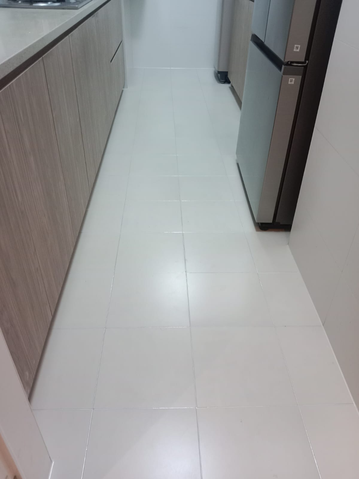 After: Same kitchen floor with fresh clean white grout lines