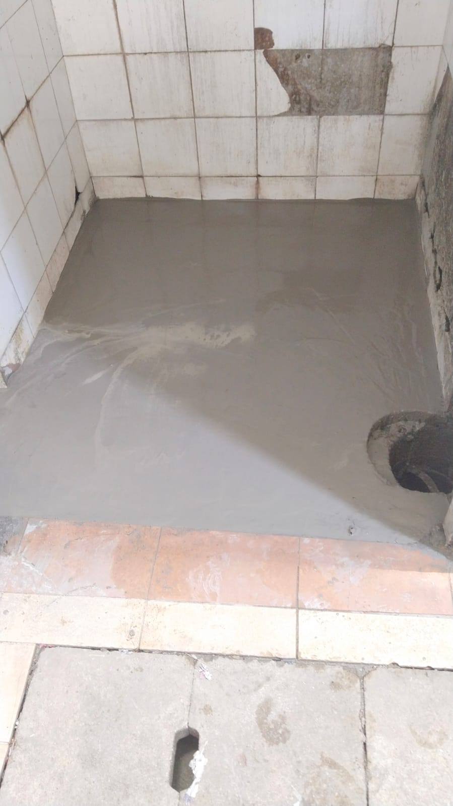 After: Fresh cement screed applied, ready for new tiles